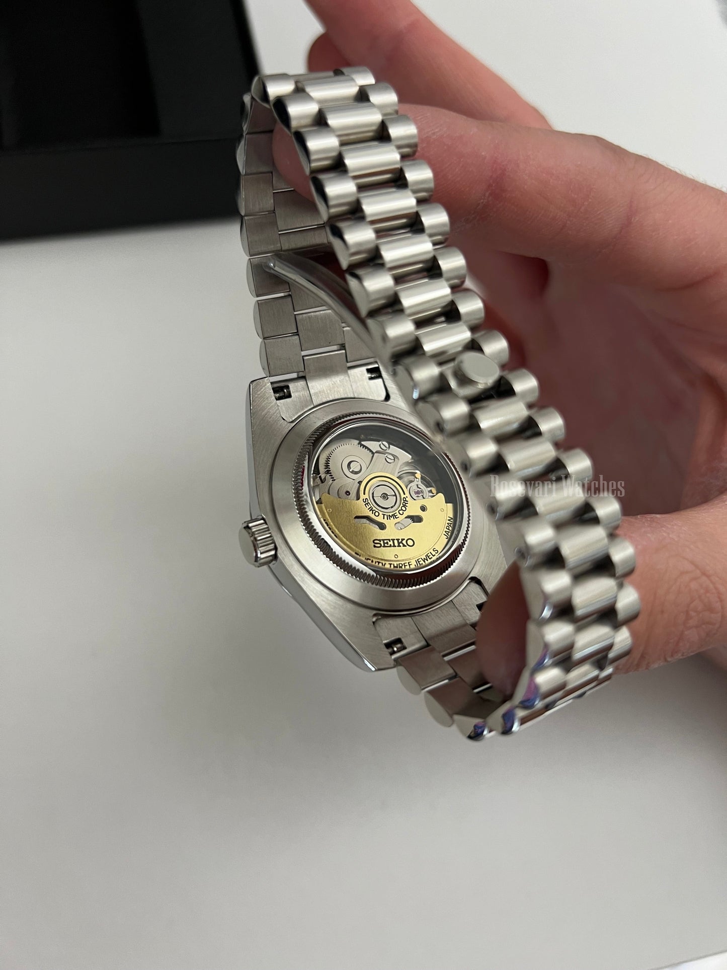 Datejust (Arabic Olive) Seiko NH35 automatic mod watch. A caseback detail showing the mechanical movement of a watch with a silver jubilee bracelet.