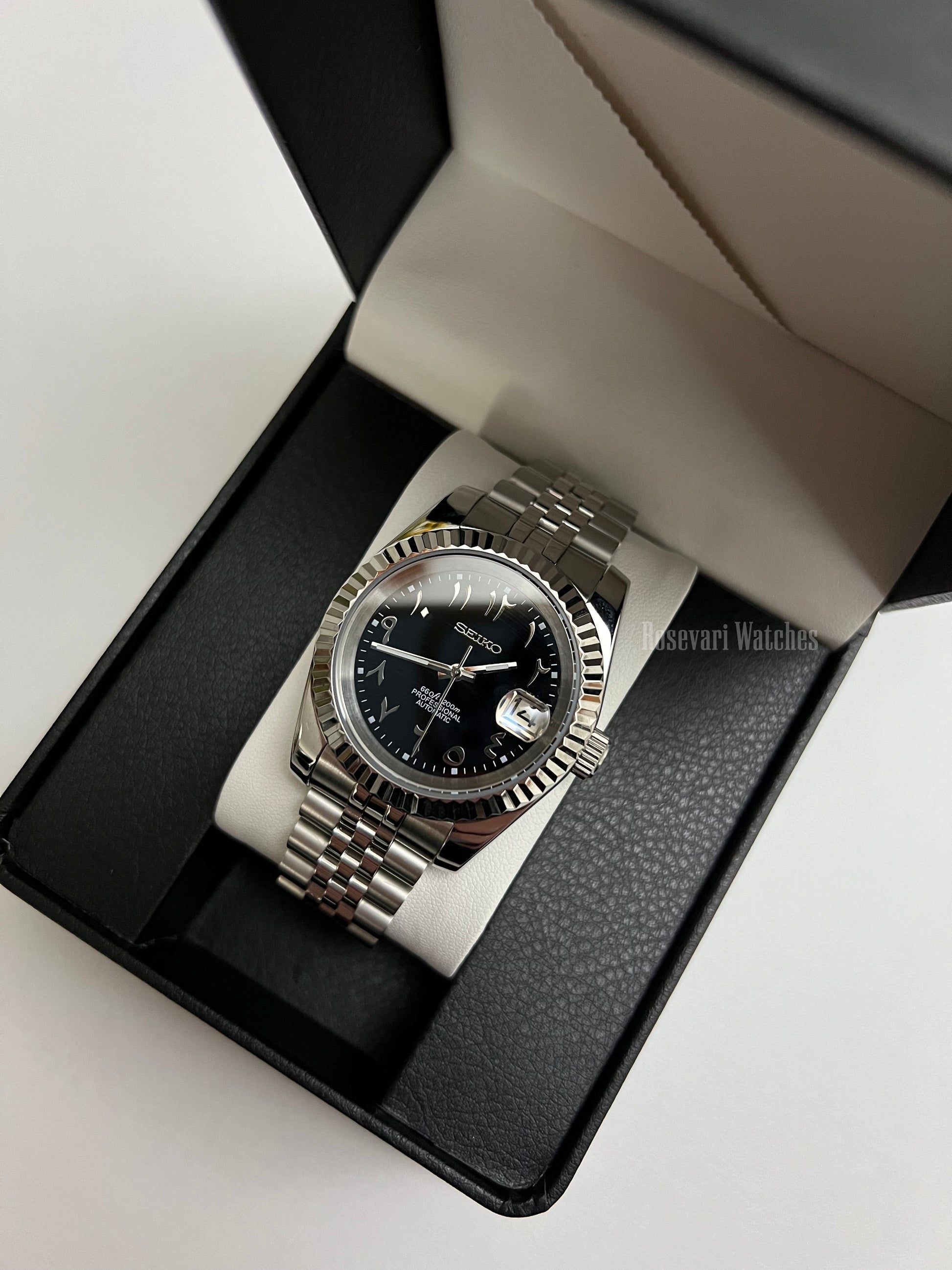 Datejust (Arabic Black) Seiko NH35 automatic mod watch. A black dial watch with a silver fluted bezel and a metal jubilee bracelet inside an open gift box.