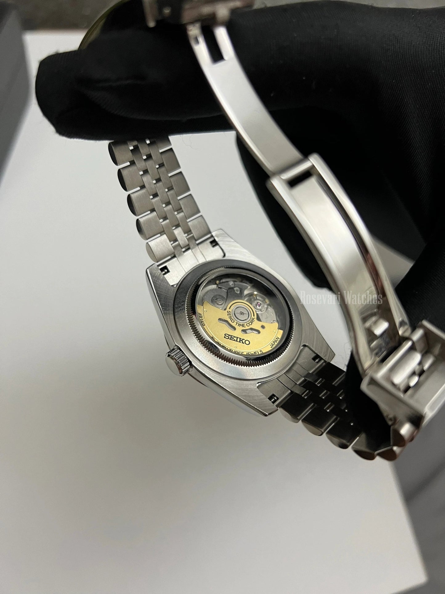 Datejust (Arabic White) Seiko NH35 automatic mod watch. A view of the watch caseback showing the mechanical movement and the jubilee bracelet.
