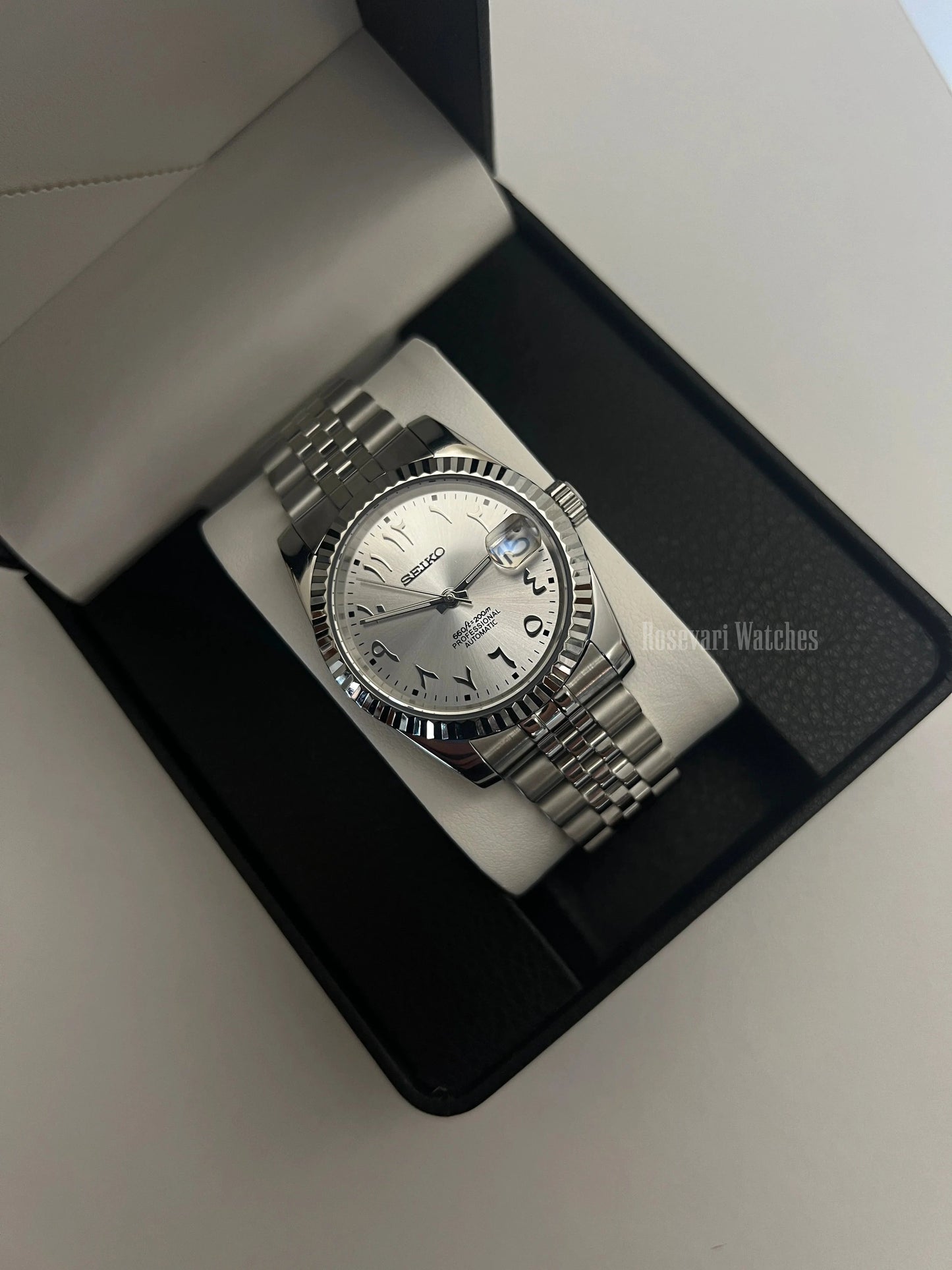 Datejust (Arabic White) Seiko NH35 automatic mod watch. A silver dial watch with a fluted bezel and jubilee bracelet inside an open watch box.