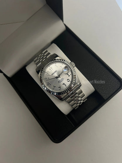 Datejust (Arabic White) Seiko NH35 automatic mod watch. A silver dial watch with a fluted bezel and jubilee bracelet inside an open watch box.