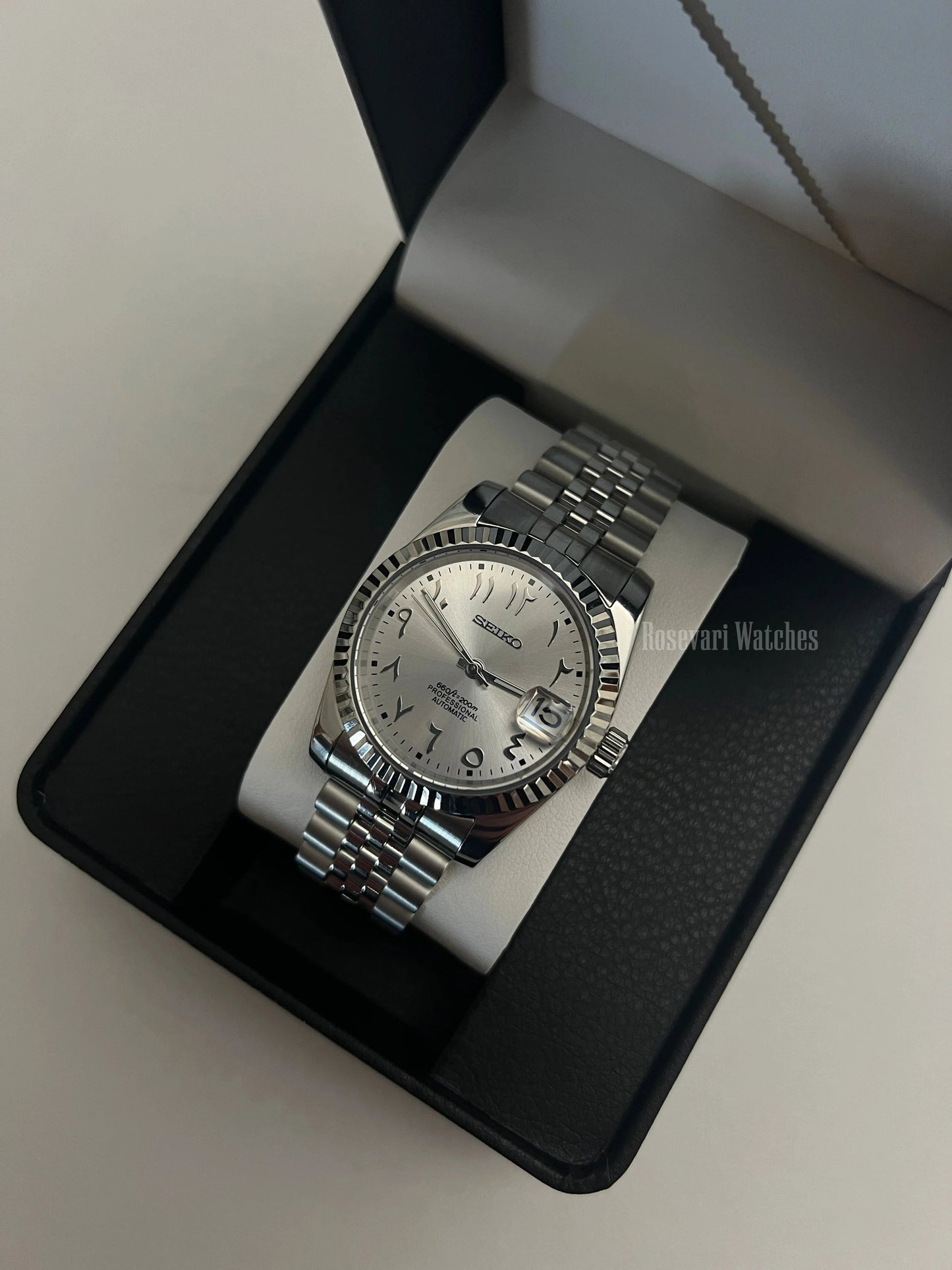 Datejust (Arabic White) Seiko NH35 automatic mod watch. A silver dial watch with a fluted bezel and jubilee bracelet inside an open watch box.