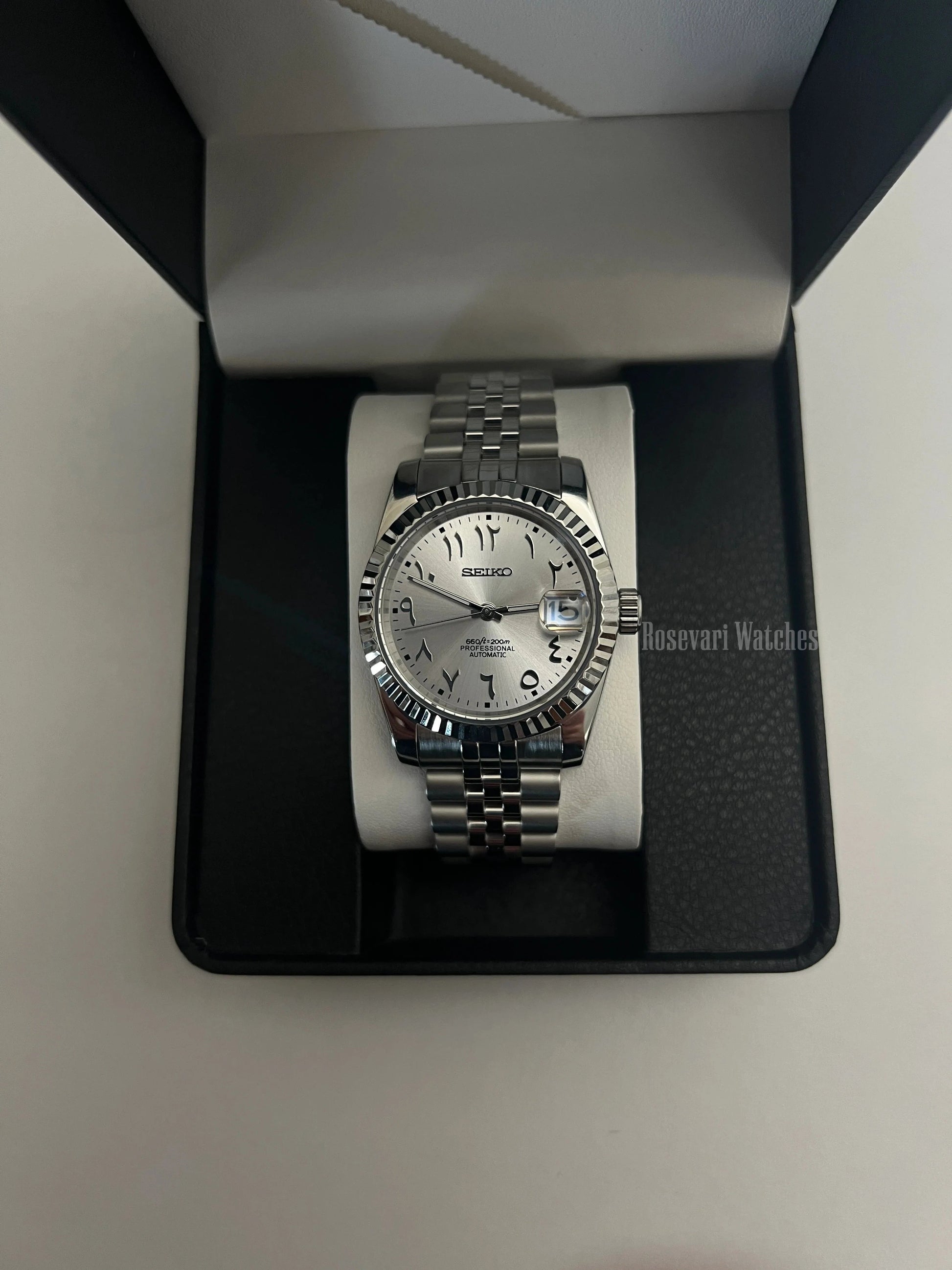 Datejust (Arabic White) Seiko NH35 automatic mod watch. A silver dial watch with a fluted bezel and jubilee bracelet inside an open watch box.