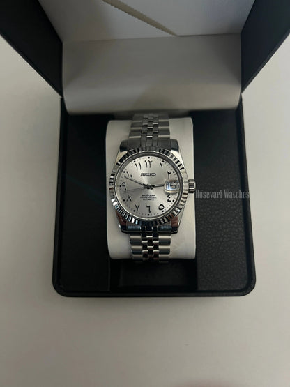Datejust (Arabic White) Seiko NH35 automatic mod watch. A silver dial watch with a fluted bezel and jubilee bracelet inside an open watch box.