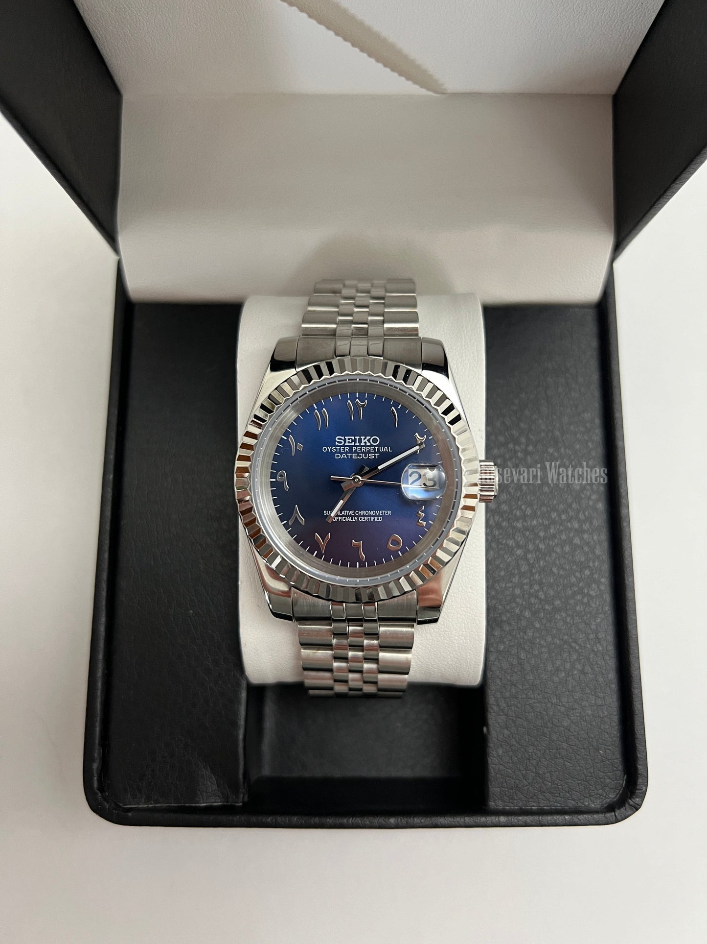Datejust (Arabic Royal Blue) Seiko NH35 automatic mod watch. A blue dial watch with a silver fluted bezel and jubilee bracelet inside an open watch box.