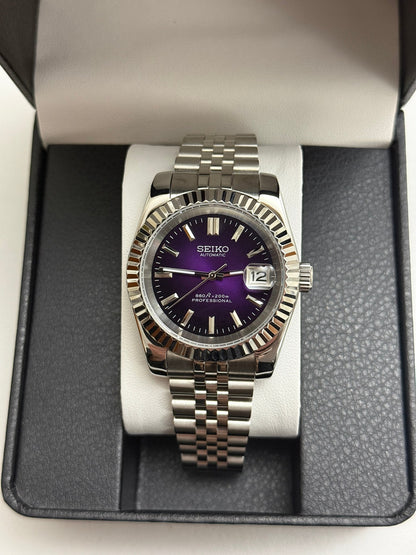 Datejust (Purple) Seiko NH35 automatic mod watch. A full watch shot inside a box showing a purple dial with a silver fluted bezel and silver bracelet.