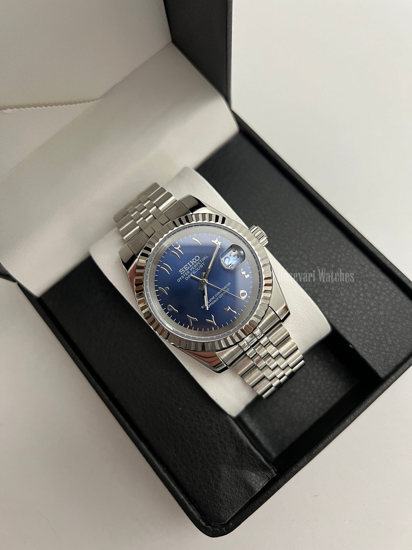 Datejust (Arabic Royal Blue) Seiko NH35 automatic mod watch. A blue dial watch with a silver fluted bezel and jubilee bracelet inside an open watch box.