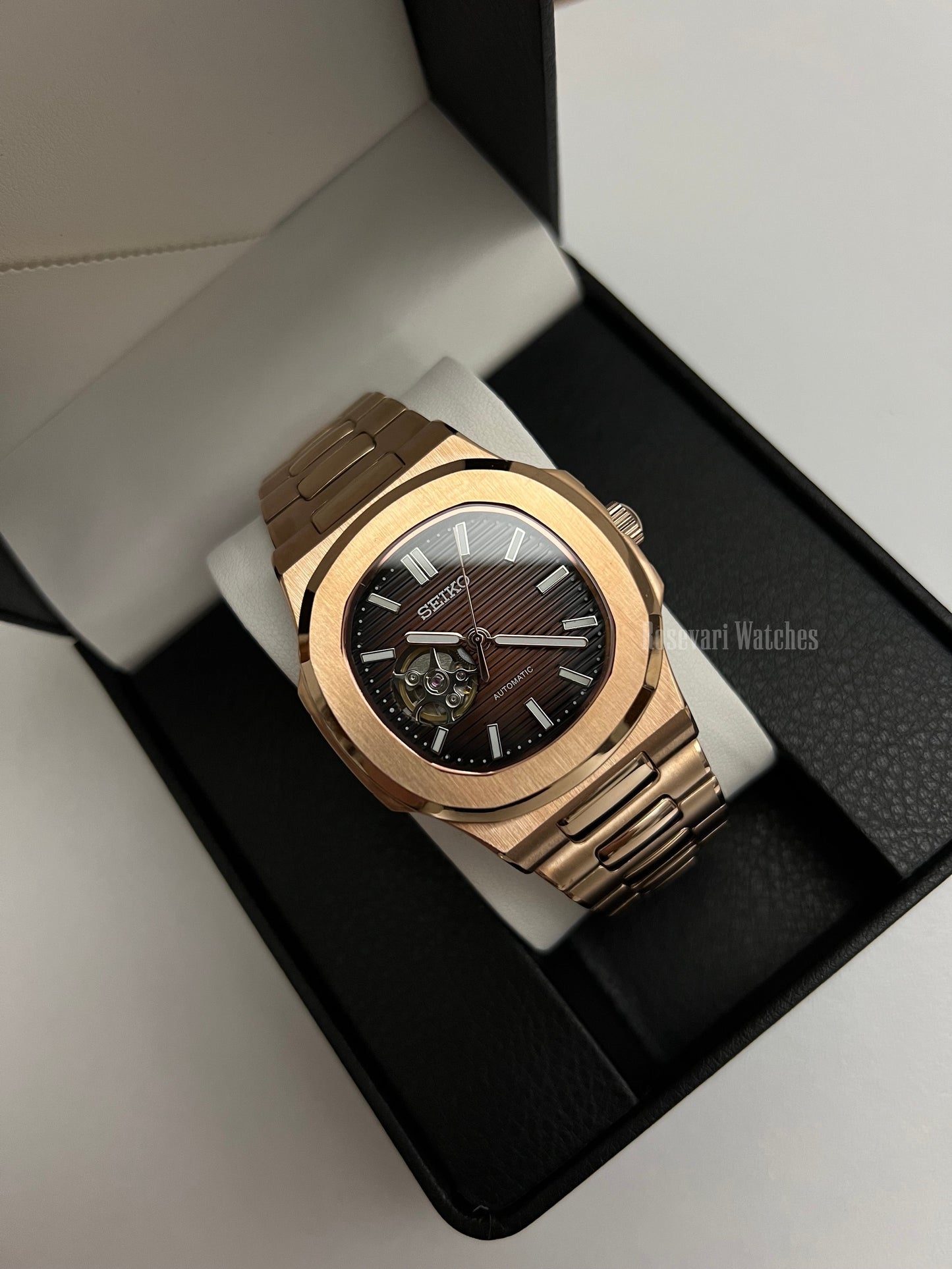 Nautilus (Open Heart, Chocolate) Seiko NH38 open-heart automatic mod watch. A full watch shot inside a box showing a brown dial with an open heart and a rose gold bracelet.