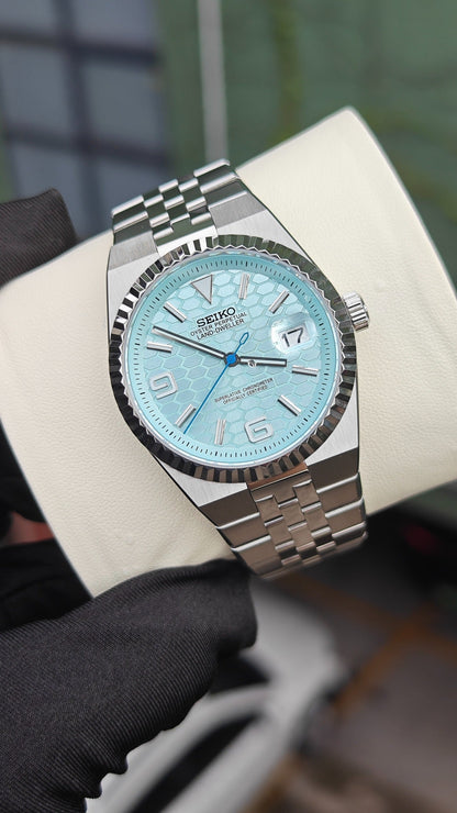Land-Dweller (Tiffany) Seiko NH35 automatic mod watch. A light blue honeycomb dial watch with a silver fluted bezel and jubilee bracelet in a full view.