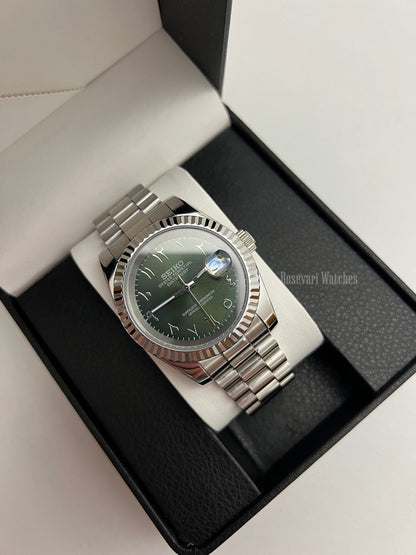 Datejust (Arabic Olive) Seiko NH35 automatic mod watch. A full watch with a green dial and silver fluted bezel on a silver jubilee bracelet inside a box.