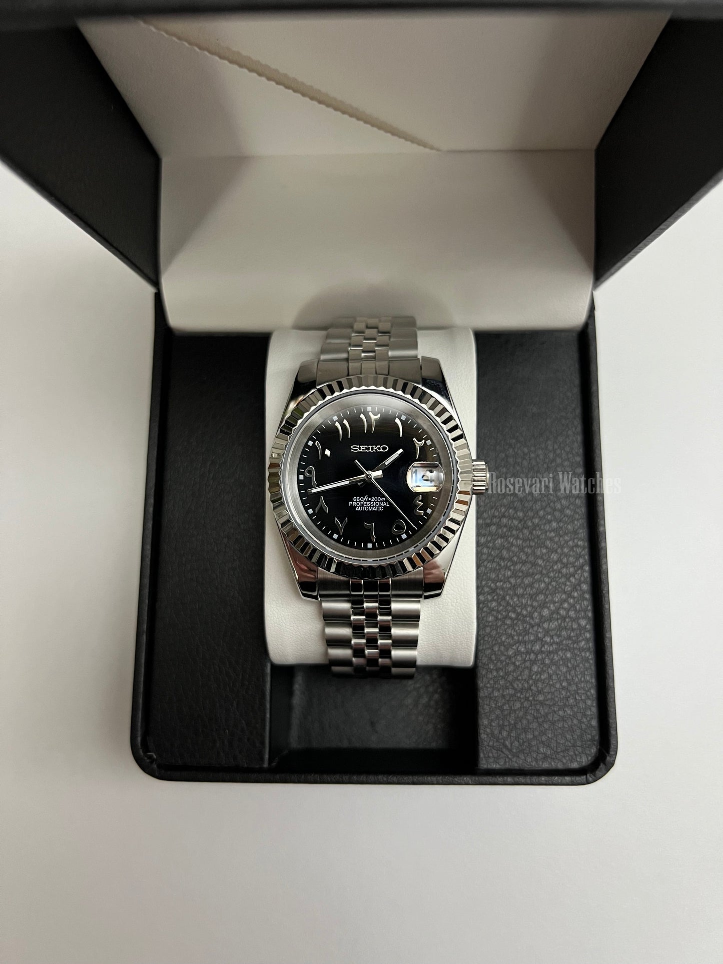 Datejust (Arabic Black) Seiko NH35 automatic mod watch. A black dial watch with a silver fluted bezel and a metal jubilee bracelet inside an open gift box.