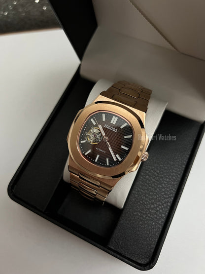 Nautilus (Open Heart, Chocolate) Seiko NH38 open-heart automatic mod watch. A full watch shot inside a box showing a brown dial with an open heart and a rose gold bracelet.