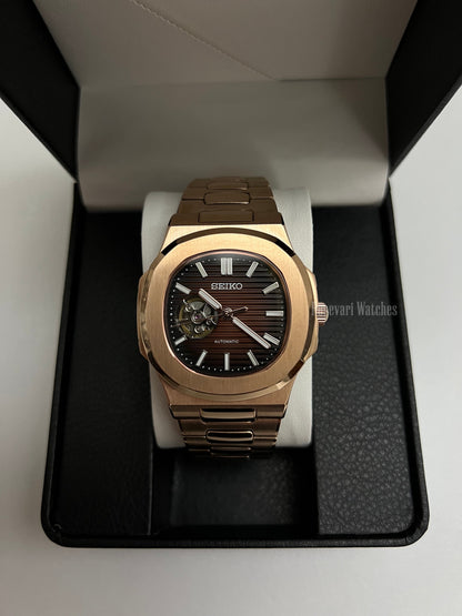 Nautilus (Open Heart, Chocolate) Seiko NH38 open-heart automatic mod watch. A full watch shot inside a box showing a brown dial with an open heart and a rose gold bracelet.