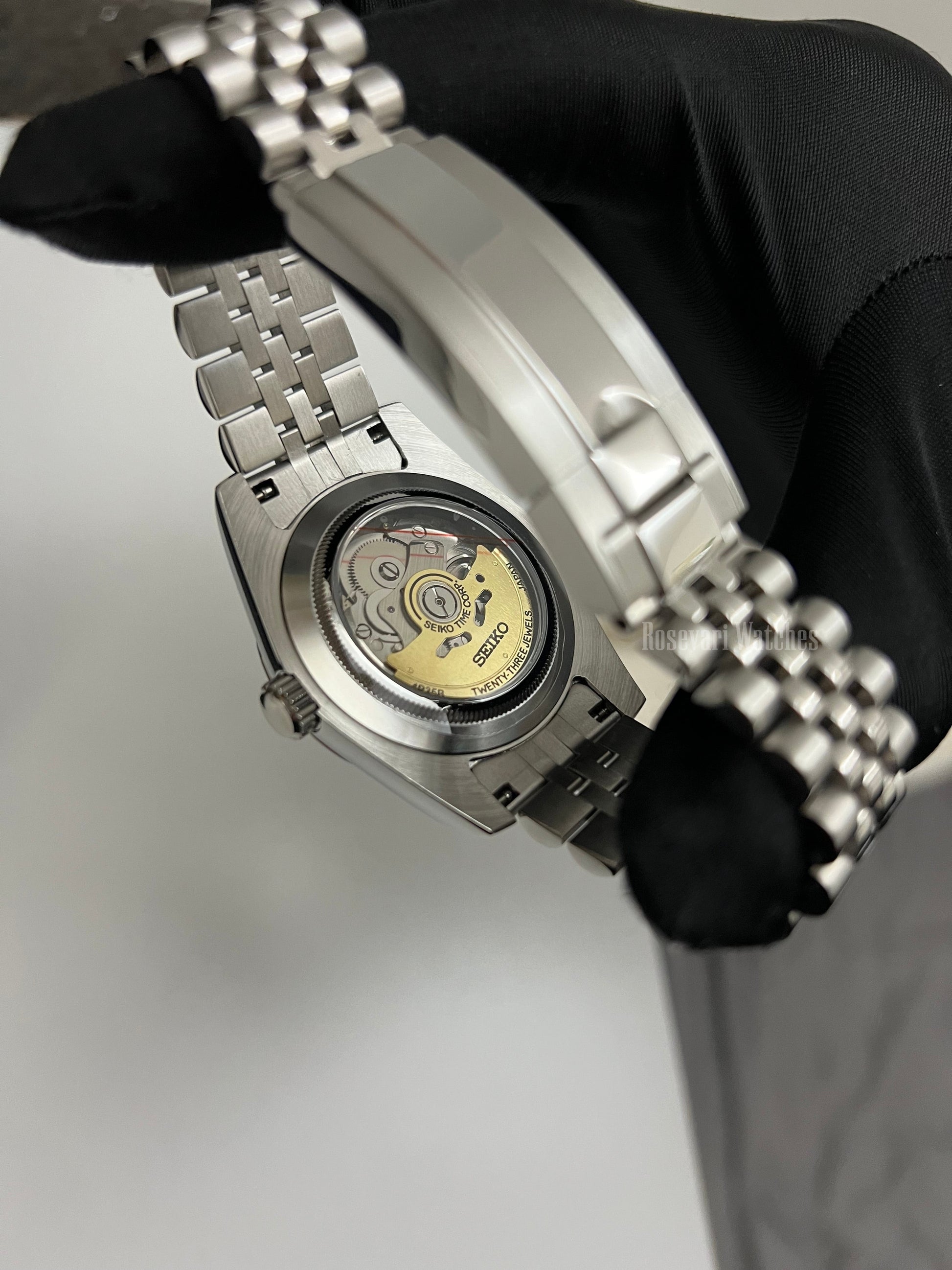 Datejust (Arabic Black) Seiko NH35 automatic mod watch. A view of the watch caseback showing the mechanical movement and the metal jubilee bracelet.