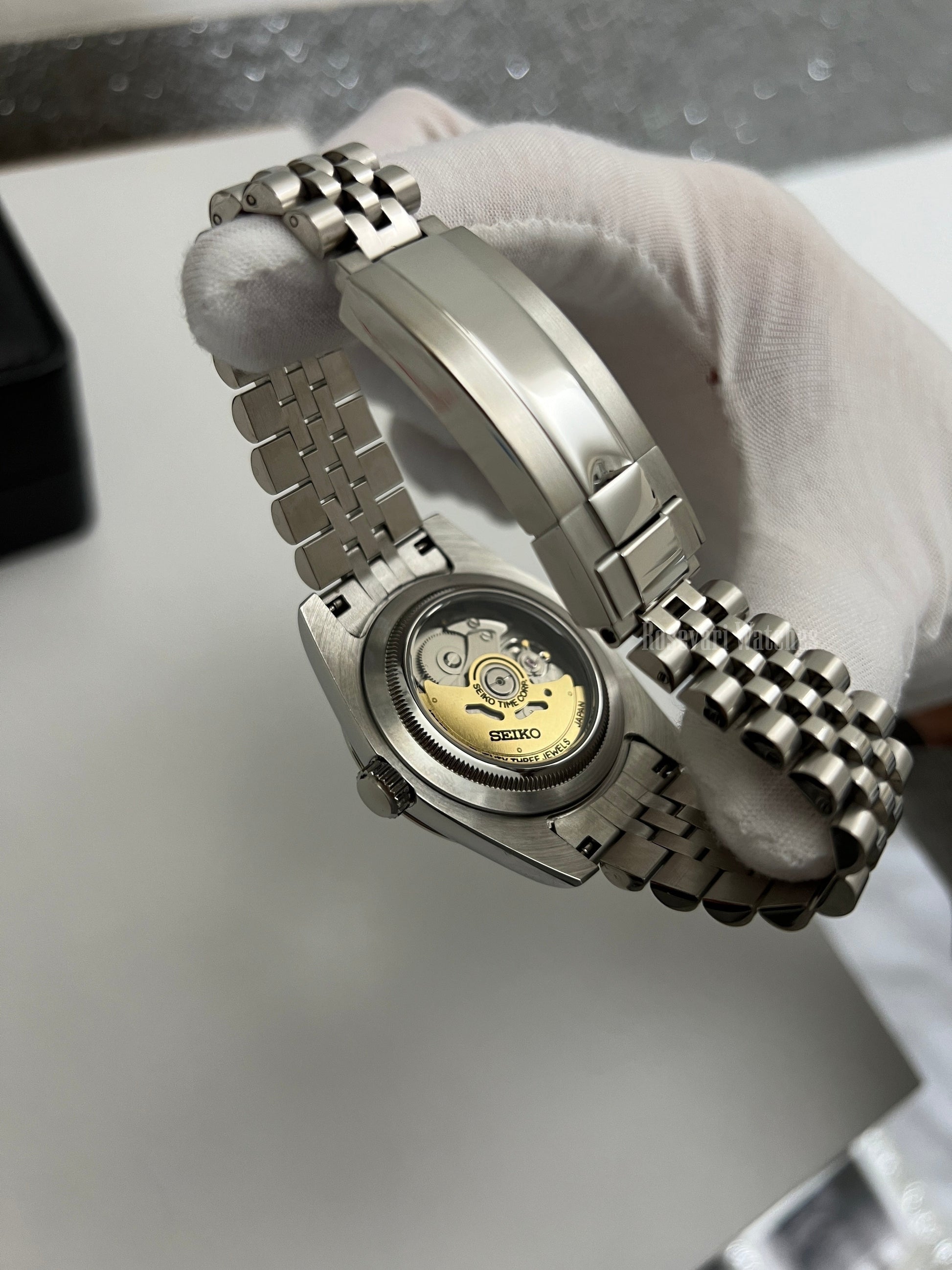 Datejust (Arabic Royal Blue) Seiko NH35 automatic mod watch. A close up of the watch caseback showing the mechanical movement and the jubilee bracelet clasp.